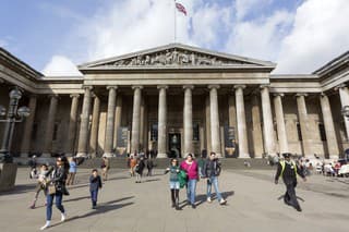 London, UK - October 17, 2013: Tourists outside the main entrance of the British Museum in London on a sunny autumn day. The British Museum is the most visited museum in UK and the third most visited museum in the world.
