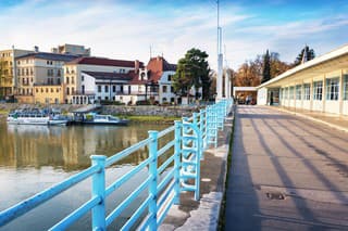 Bridge to spa island in Piestany + Vah river + riverbank + blue sky (Slovakia)
