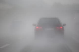 driving car on the motorway with heavy rain and fog