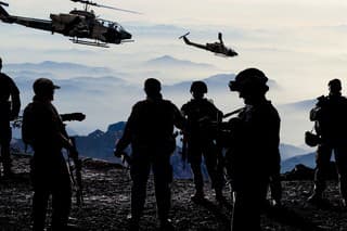 Silhouettes of soldiers during Military Mission at dusk