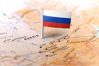 The flag of Russia pinned on the map. Horizontal orientation. Macro photography.