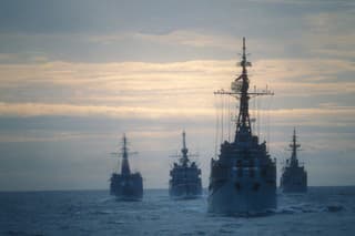 Four frigates doing an exercise on the ocean at the end of the day.I used a slide film