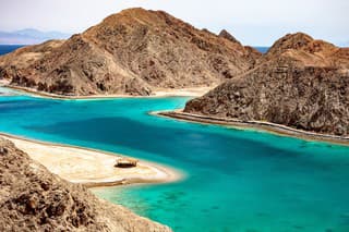 Beautiful Panoramic view of the Fjord Bay Taba in Aqaba Gulf, Egypt. Turquoise clear water of Red Sea and rocky mountains around.