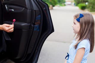 Stranger in the car offers candy to the child. Kids in danger. Children safety protection kidnapping concept