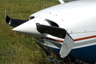 Front of a private airplane with a severely damaged propeller