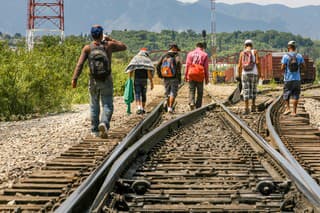 Coahuila, Mexico, Jun 16 - A group of migrants of Central American origin waits on the railway line to get on a container train, known as 'The Beast', to go to the border of the United States and Mexico, between the states of Coahuila (Mexico) and Texas (USA).