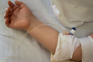 Little patient, child sick  in the hospital with saline intravenous (IV).Close-up. Recovery,health care treatment.