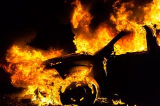 Car in fire, burning at night