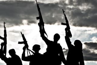 Silhouette of several muslim militants with rifles