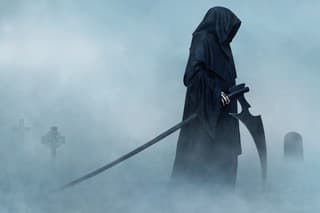 Grim Reaper walking in fog. Halloween.