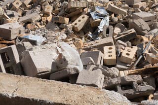 Rubble of pieces of a building consisting of brick and concrete and matel.