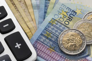 Close up of a calculator and euro money in a financial analyzing concept
