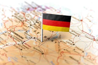 The flag of Germany pinned on the map. Horizontal orientation. Macro photography.