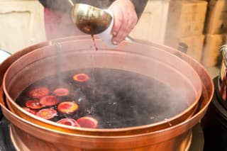 Christmas market and a pot of mulled wine with fruit and spices