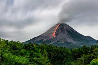 Incandescent lava avalanches from the lava dome of Mount Merapi, Yogyakarta, Indonesia