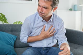 Man suffering from gastric reflux after dinner