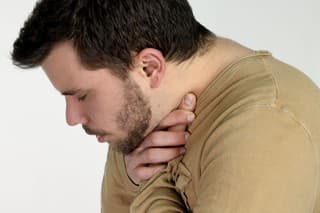 first aid - young man choking over a white background