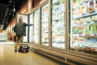 Shot of a mature man shopping in the cold produce section of a supermarket