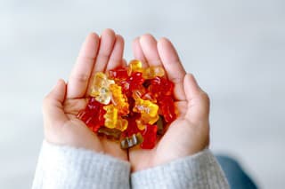 Top view image of a woman holding colorful Jelly gum in hands