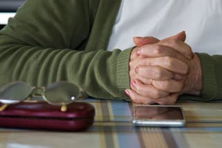 older woman's hands with mobile phone