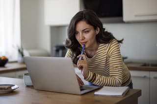 Young woman using a laptop while working from home