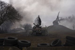 Na archívnej snímke z 24. februára 2022 dym stúpa pri zásahu protivzdušnej obrany po ruskom útoku na prístavné mesto Mariupoľ.