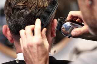 Closeup shot of a man getting his hair cut at salon