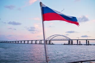 sea sunset, view of the Crimean bridge, the flag of Russia on the yacht, photo from the yacht