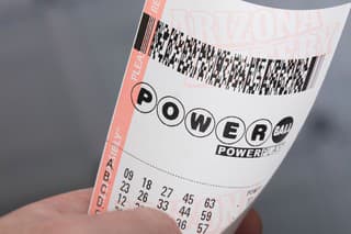 Kingman, USA - January 20, 2016: A photo of a man holding a Powerball lottery ticket in Kingman, Arizona. 