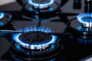 Four kitchen gas stoves burning with natural gas