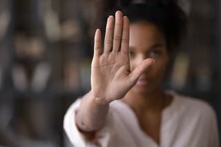 Close up focus on female mixed race palm hand showing stop sign, serious african american woman protesting against bullying in society, sexual or racial discrimination, denying family abuse indoors.