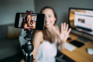 Beautiful woman vlogging at home