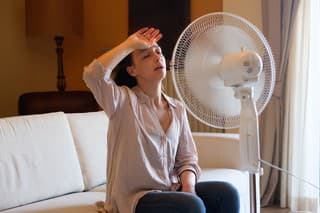 Woman feeling hot and trying to refresh in summertime heat