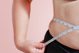 soft focus measure your body fat percentage with measuring tape for fat or obesity background