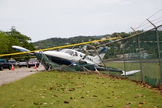 small plane crashes through fence in emergency landing