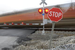 Blurred train moving past a railroad crossing