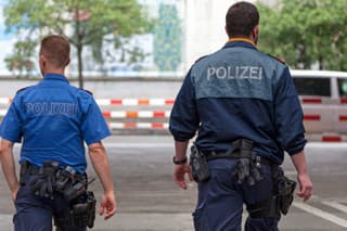 Zurich, Switzerland - June 13 2018: Two police officers patrolling inside the Zürich Hauptbahnhof (often shortened to Zürich HB) where is held a market place.
