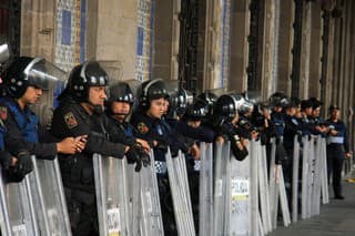 Mexico City, Mexico - November 24, 2015: Mexican Police Officers in Riot Gear outside building in Zocalo Square, Mexico City 