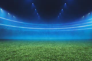 Digital Football stadium view illuminated by blue spotlights and empty green grass field. Sport theme digital 3D background advertisement illustration design template