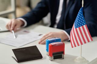 Close up of approved and rejected stamps on table in US immigration office with flag, copy space