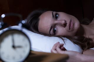 Woman lying in bed suffering from insomnia