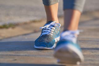 view of feet of sporty woman walking, copy space, unfocused view