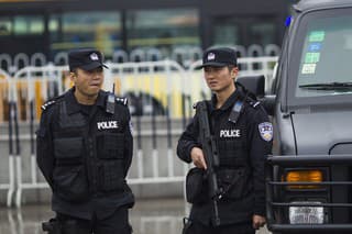 Guangzhou, Сhina - March 6, 2015: Armed paramilitary policemen stand guard in front of the Guangzhou Railway Station after a knife attack, in Guangzhou, Guangdong province, March 6, 2015. Knife-wielding attackers slashed and stabbed people at a railway station in the southern Chinese city of Guangzhou, wounding at least nine before police shot dead one of the suspected assailants and arrested another. 