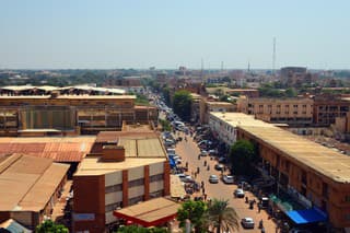 Ouagadougou, Burkina Faso - October 13, 2015: people and traffic along Maurice Yameogo avenue, the commercial center of the city