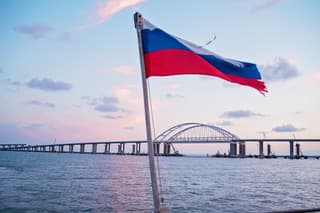 sea sunset, view of the Crimean bridge, the flag of Russia on the yacht, photo from the yacht