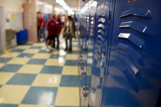 blue school hallway lockers and checkered tile in high school students in the background (down-sampled to increase sharpness)