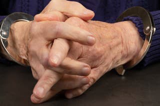 Close up photo of a handcuffed elderly woman