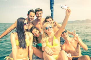 Group of friends on a boat taking a selfie