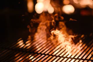 Flame through Barbecue Braai Grid at Night