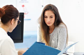 Picture of adult woman having a visit at female doctor's office